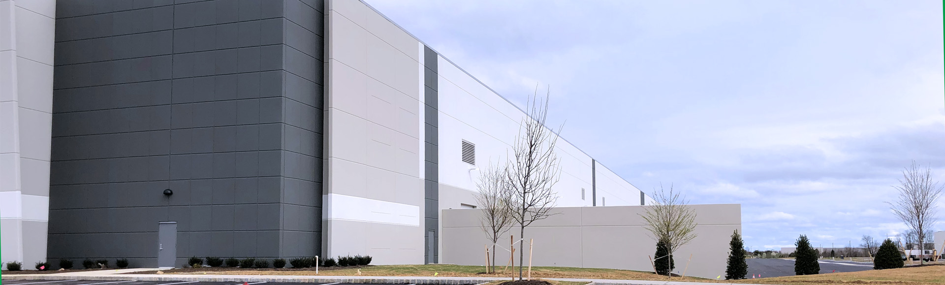 Ground view of the side of an industrial warehouse showing closeup of the rear entrance.