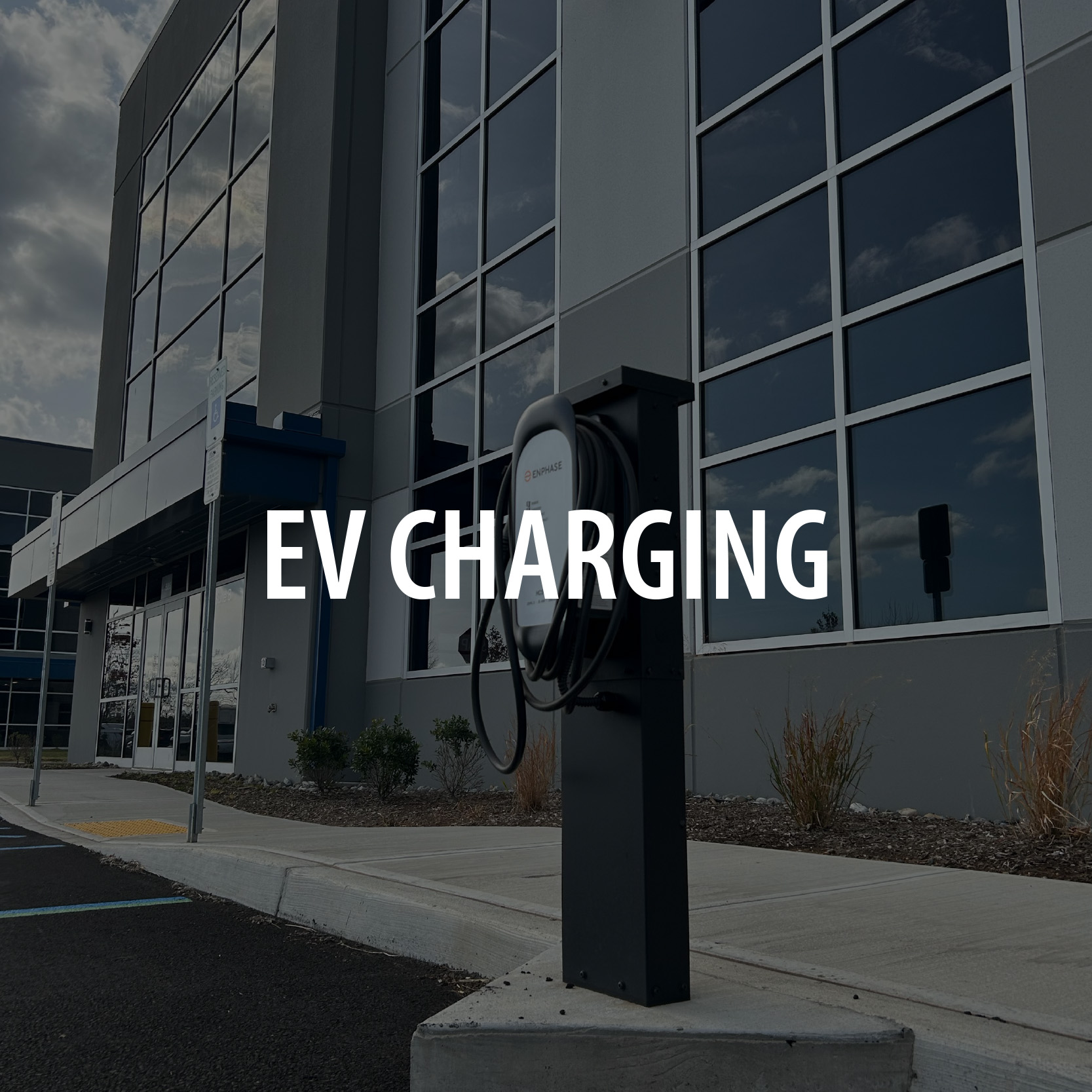 Image of industrial building with EV charging station near the front entrance