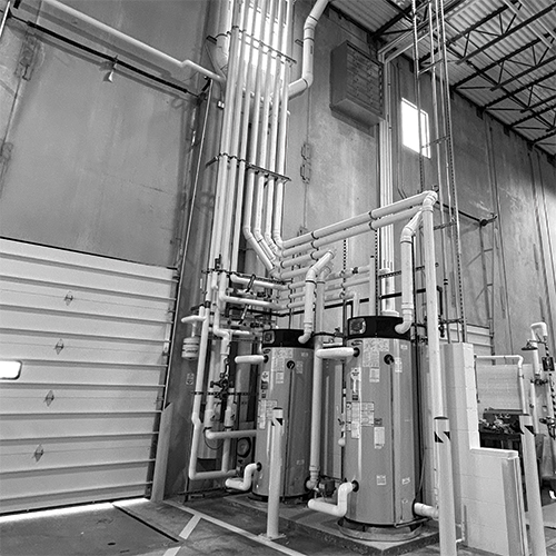 Black/white photo of exposed MEPs within a warehouse